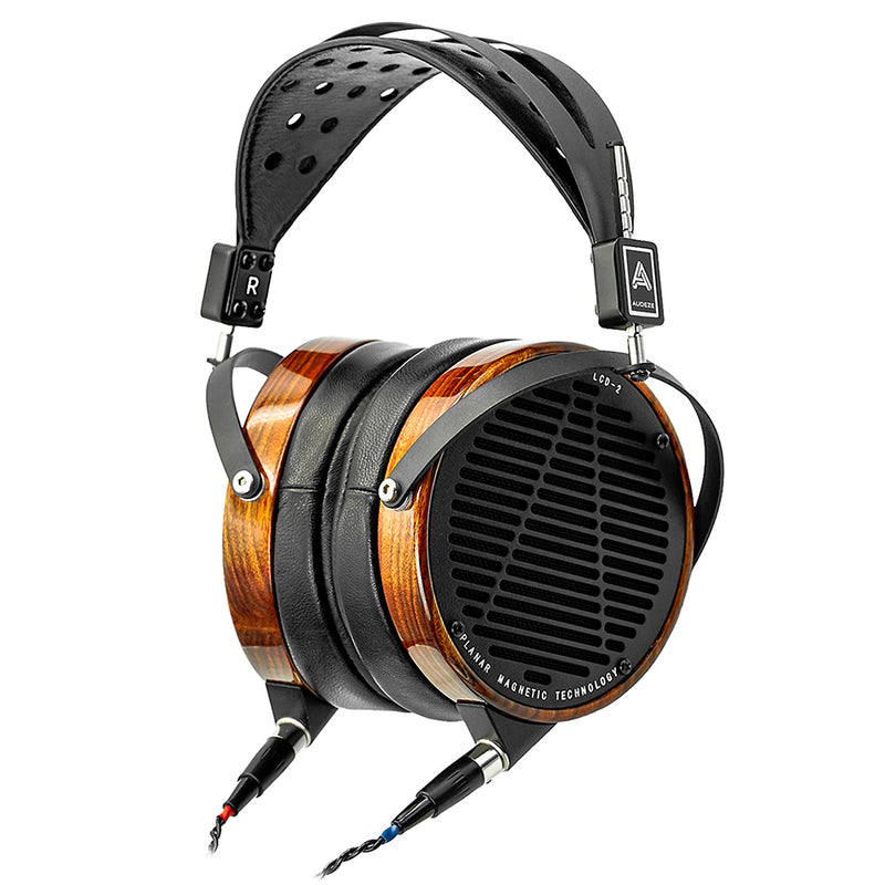 Headphones with wood accents on earcups and cables plugged in the bottom
