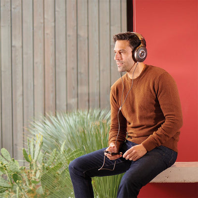 Man sitting at a bench listening to headphones
