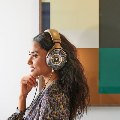 Woman listening to headphones at a window