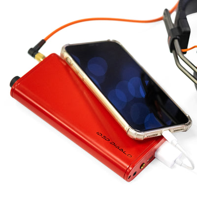 Red USB digital to analog audio device plugged into a smartphone